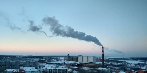 chimneys giving off smoke into the atmosphere