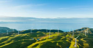 mountains with windmills with the ocean in distance