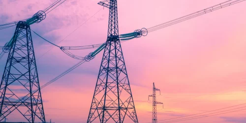 Three Electric pylons with a sunset in the background