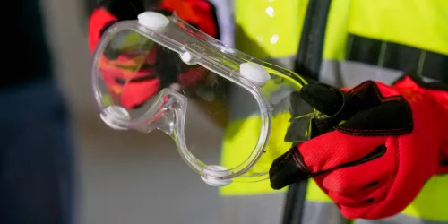 Why Irish and Northern Irish Councils Need ISO 45001: Protecting Staff and Strengthening Health & Safety Culture 1 Someone holding safety goggles