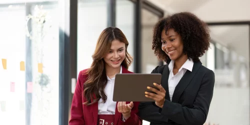 Two women discussing fintech in an office